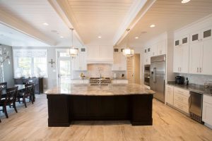 A large kitchen with hardwood flooring and granite countertops