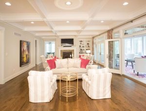 Living space with hardwood flooring and high ceiling